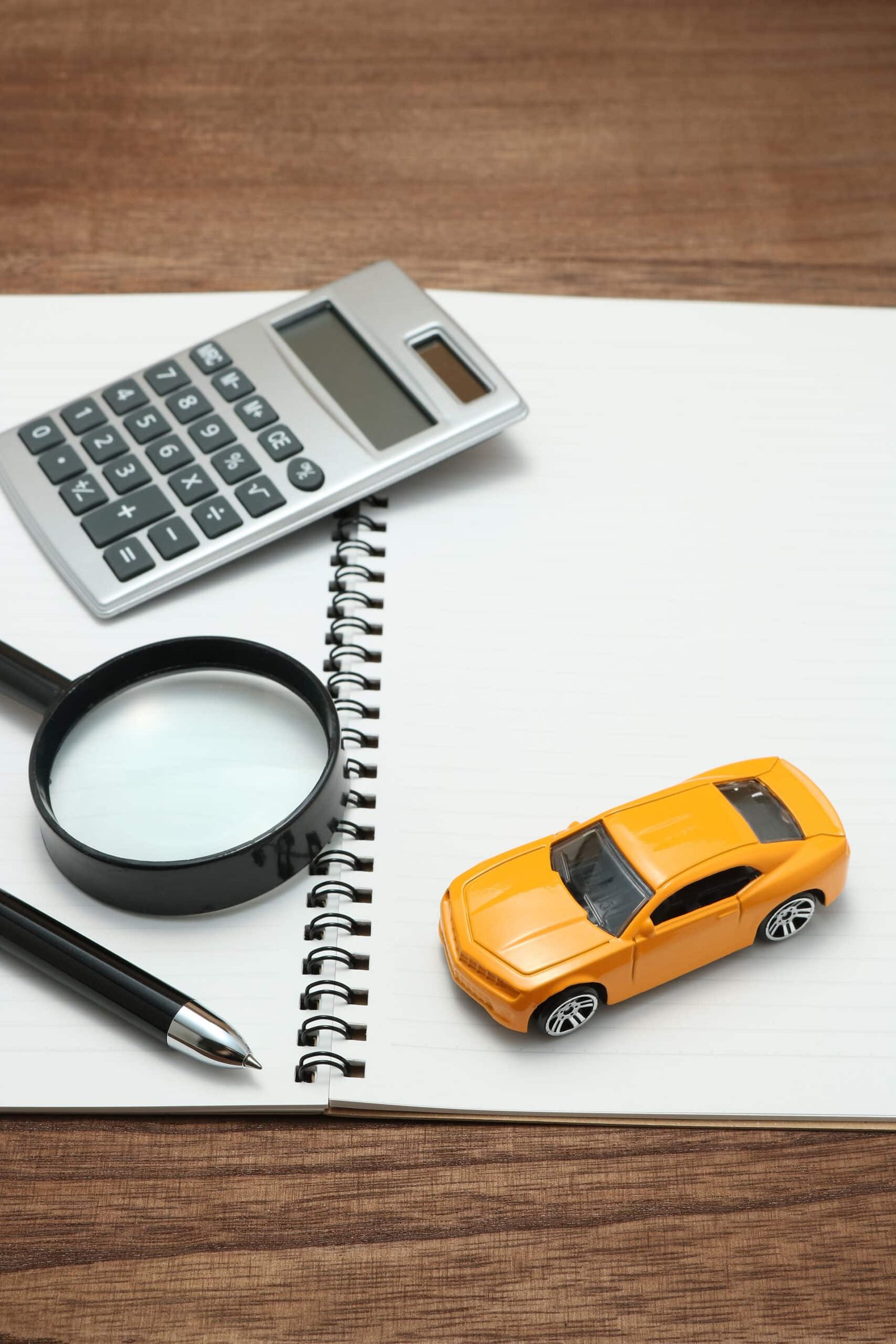 high-angle-view-toy-car-calculator-diary-table (1)